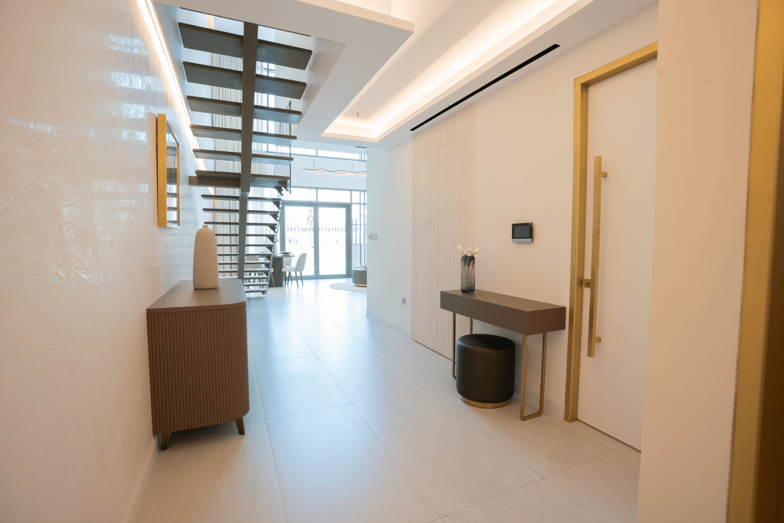 Elegant hallway with modern decor and staircase leading into the main living area.